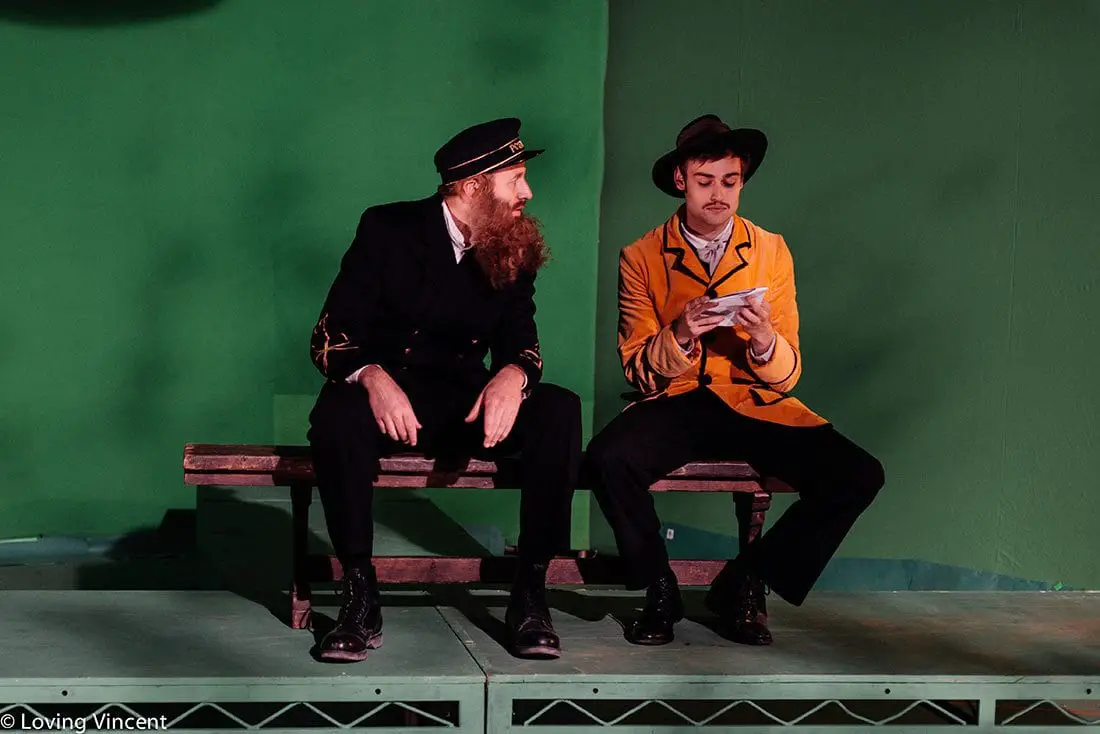A man dressed as a ship captain and a man in a yellow blazer and hat as models for Van Gogh