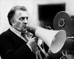 Federico Fellini uses a bullhorn to set up his next shot.