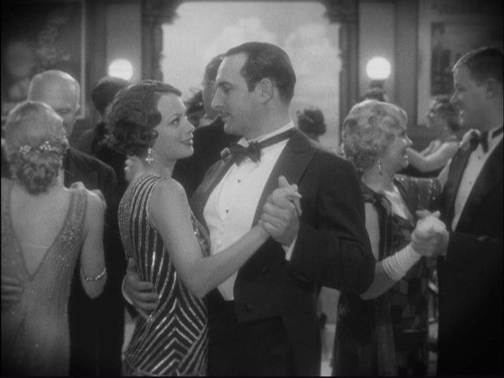 Jean Dujardin dances with a female in a ballroom set in the 1920s in The Artist