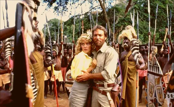 Alan Quartermain and Jesse Huston embrace as a tribe of Gagoola's warriors surround them