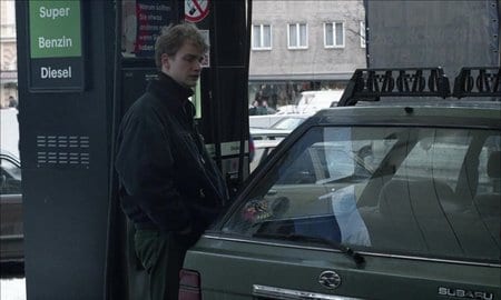 a man fills his car with gas in 71 Fragments of a Chronology of Chance (1994)