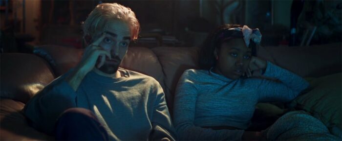 While taking shelter in a stranger's home, Connie (Robert Pattinson) sits with Crystal (Taliah Webster).