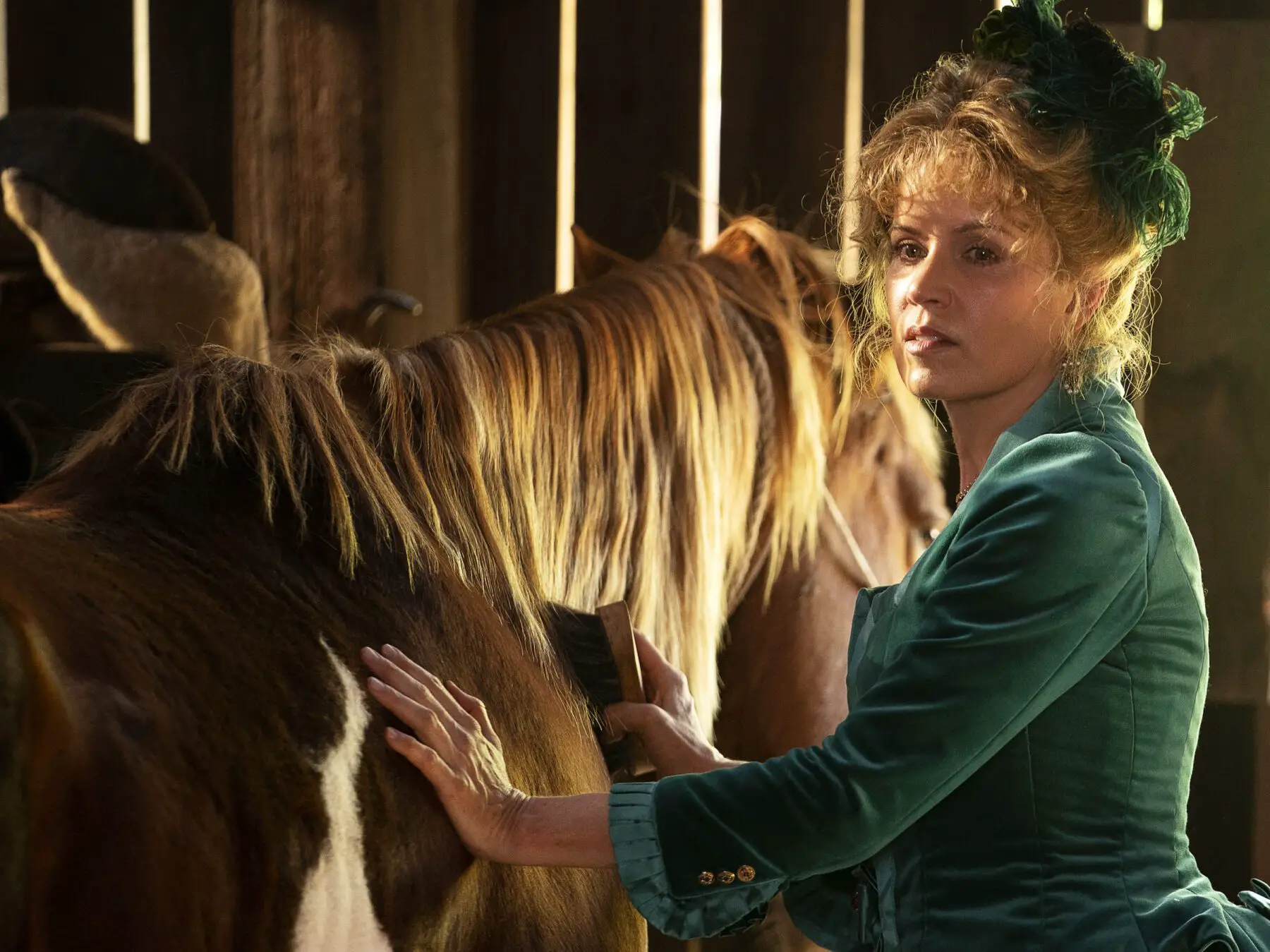 Joanie Stubbs brushes Charlie Utter's horse