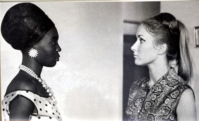 A Black Senegalese woman and her white French employer look squarely at one another in a tense scene.