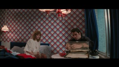 Sally (Nancy Allen) and Jack (John Travolta) sit in a bedroom.