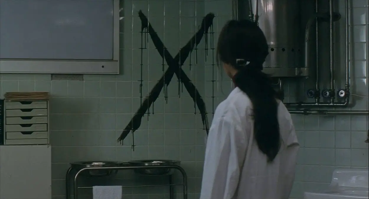 A woman looks at an X in a hospital room
