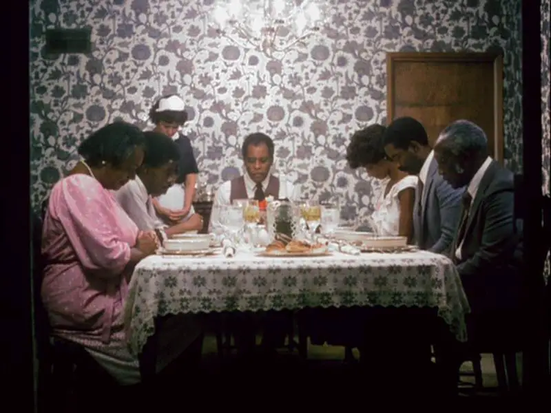 The Mundys and the Richardsons sit at the table and say grace before dinner 