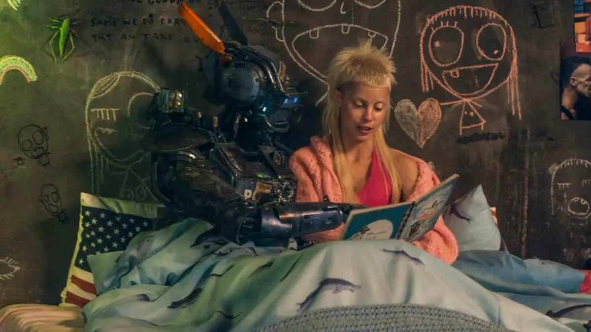 Yolanda reads Chappie his book, The Black Sheep, as they sit in bed together. 