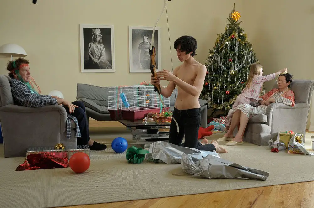 Kevin (Ezra MIler) unboxes his future weapon for Christmas while Eva (Tilda Swinton) looks on distraught