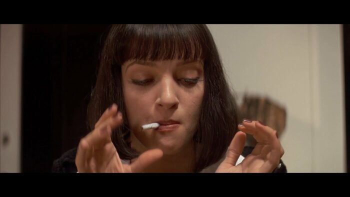 Mia Wallace smokes a cigarette
