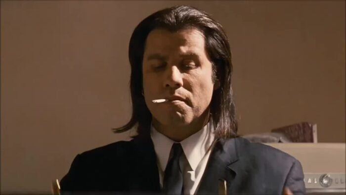Vincent Vega (John Travolta) smokes a cigarette