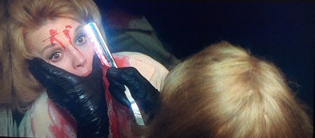 Kate Miller (Angie Dickinson) has her face slashed in an elevator in Dressed to Kill.