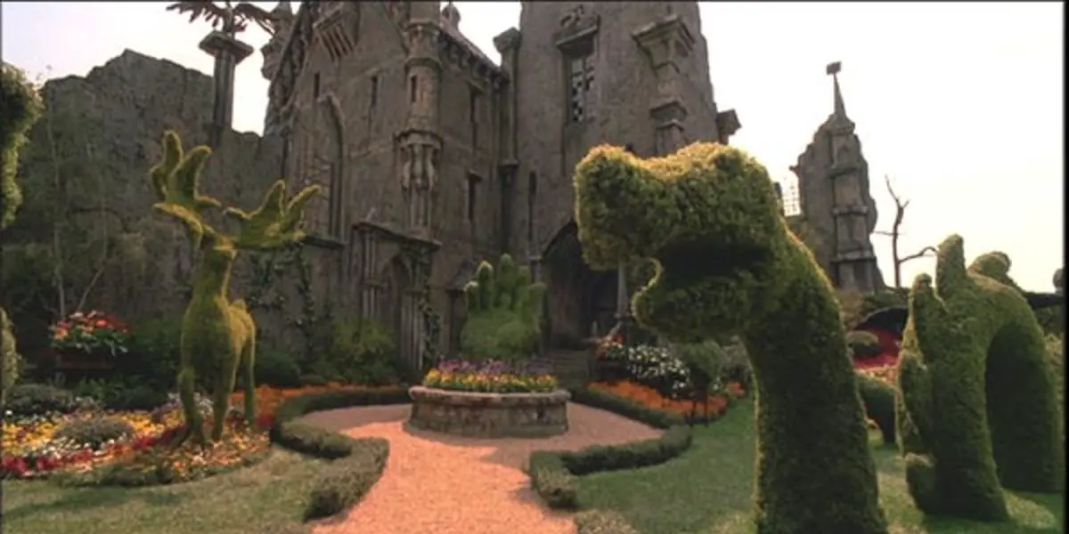 The Castle of Edward Scissorhands with topiary animals in the front garden
