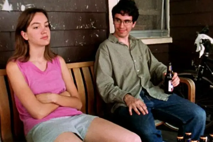 Marnie sits on the porch of her apartment with her former co-worker Mitchell in Funny Ha Ha.