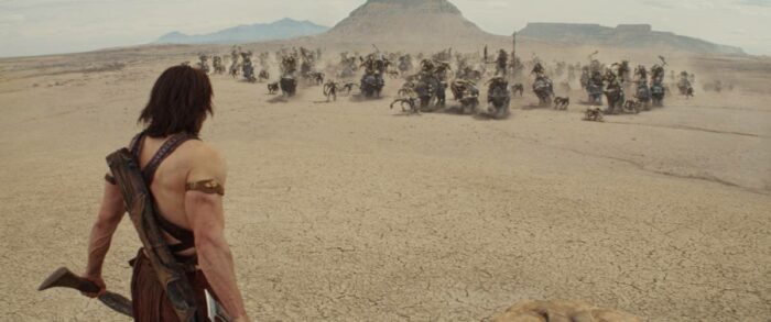 John Carter, with sword drawn, stands down an army of Tharks by himself.