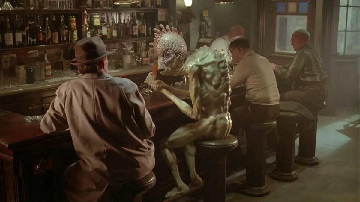 Peter Weller talks to a Mugwump in a bar