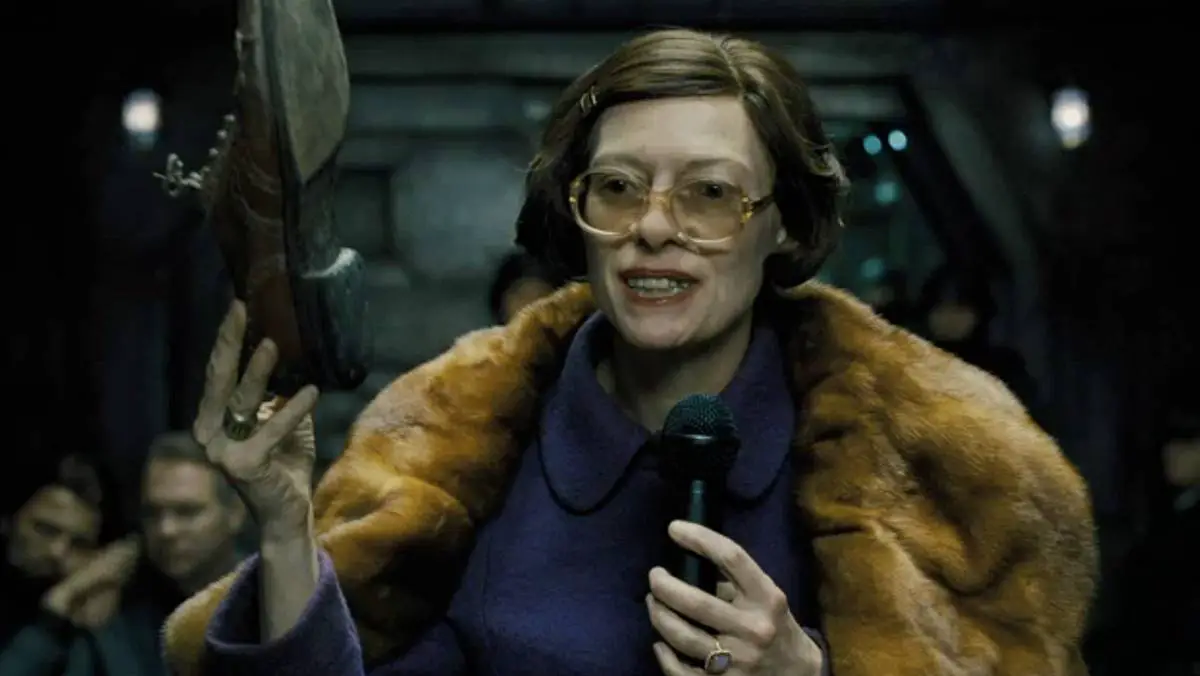Mason (Tilda Swinton) holds up a worn shoe in an attempt to explain the different classes on the Snowpiercer