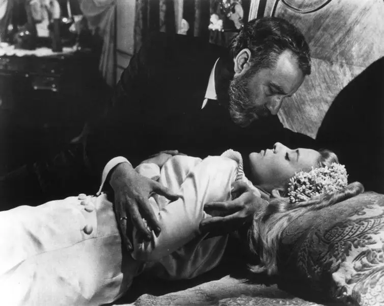Don Jaime (Fernando Rey) takes advantage of a drugged Viridiana (Silvia Pinal), who is lying on a bed wearing his late wife’s wedding dress. 