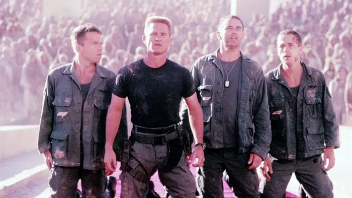 The military crew stand in judgement of the alien god Ra in Stargate.