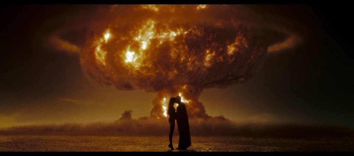 Dan and Laurie embrace in front of a nuke going off