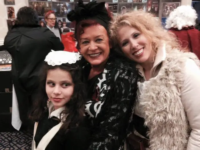 Gracie (Cat Smith's daughter), Patricia Quinn, and Cat Smith all pose for a photo together at con.