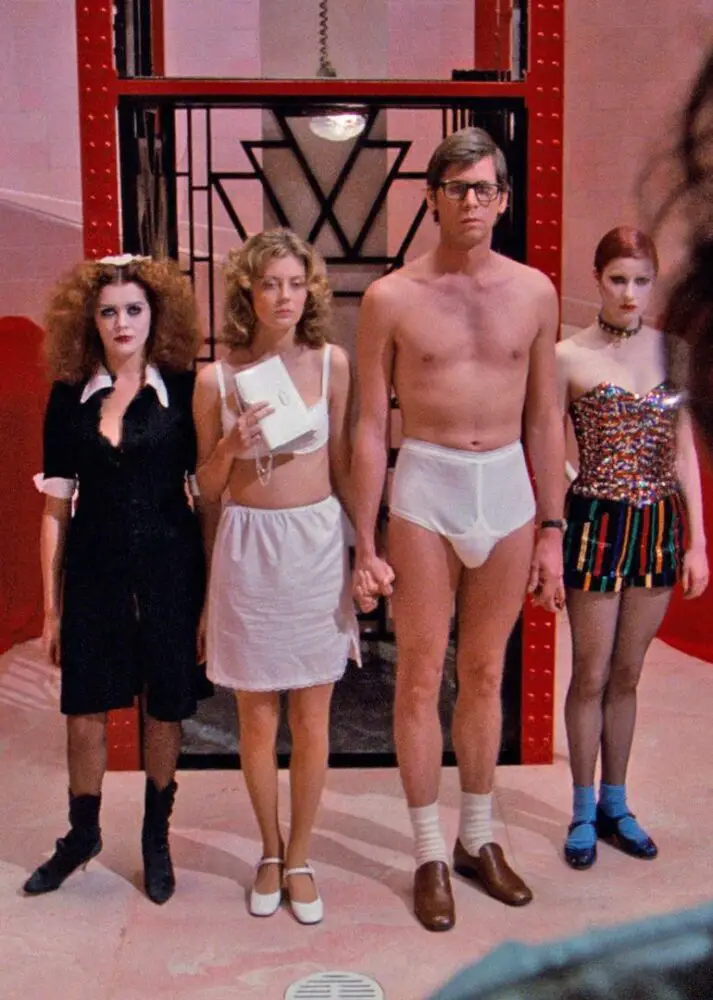 Brad and Janet stand in their underwear next to Magenta and Columbia