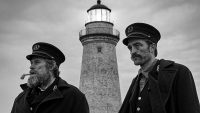 Thomas (left) and Ephram (right) stare at their departing ship in front of their lighthouse post.