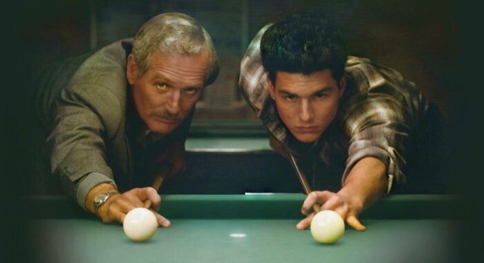 Fast Eddie Felson and his young protege Vincent line up shots on a green pool table