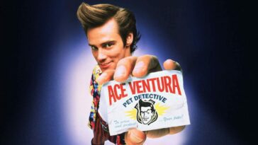 Ace holds his business card, bearing the title of the film, up to the camera