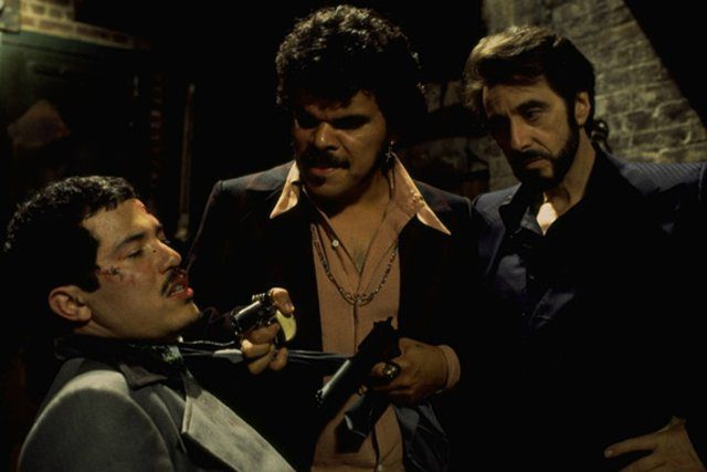Carlito and Pachanga grab Benny Blanco in a back alley and threaten him with a gun
