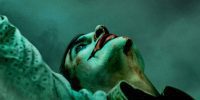 Joaquin Phoenix is the titular Joker with clown face looking up at the sky