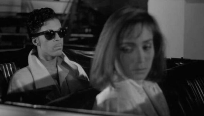 Christopher Tracy (Prince) and Mary Sharon (Kristin Scott Thomas) sit in silence in a car in Under the Cherry Moon.