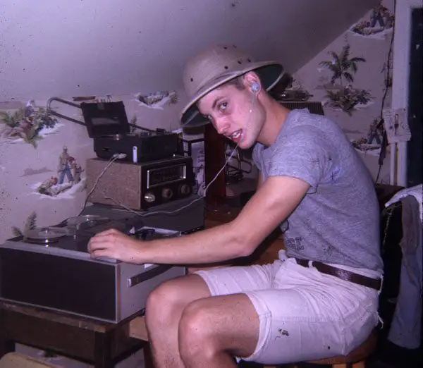 A young Ben Burtt adjusts knobs on a recording device in a bedroom