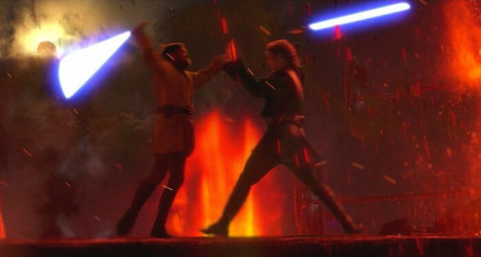 Anakin and Obi-Wan battle for their lives using lightsabers on the firey planet Mustafar