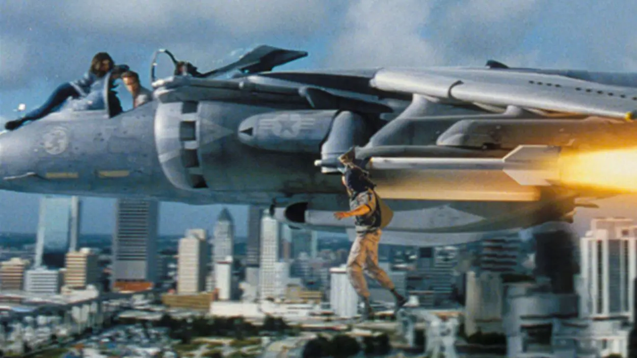 Aziz hangs from the plane's missile piloted by Harry, and his daughter Dana holds onto the pilot window