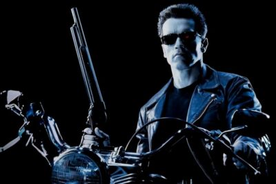 Arnold Schwarzenegger's terminator on a motorcycle, holding a shotgun and wearing sunglasses