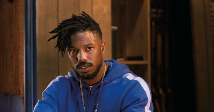 Killmonger sits in a room, confronting his demons literally and figuratively