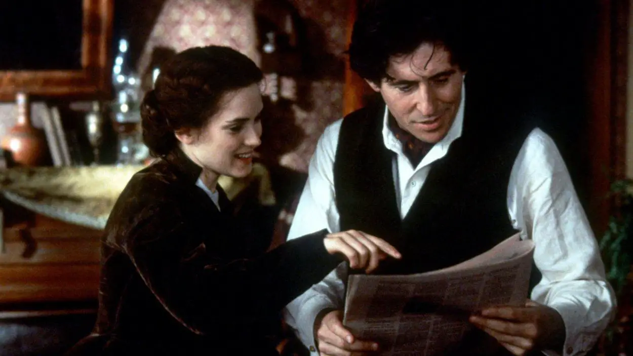 Jo (Winona Ryder) points to part of her newspaper article as Friedrich (Gabriel Byrne) reads it.