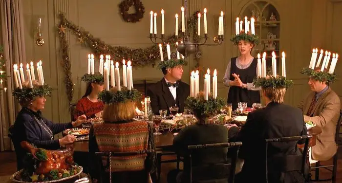 Gus sits at a table with the Chasseur family during a Christmas eve ritual 