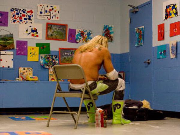 Randy the Ram sits on a chair in a classroom acting as a locker room, facing the wall