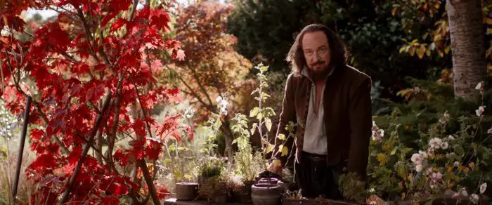 William Shakespeare stands in his garden surrounded by trees