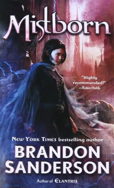 The cover of Mistborn, which features a young woman in black clothing holding two black daggers while large Gothic architecture looms in the background