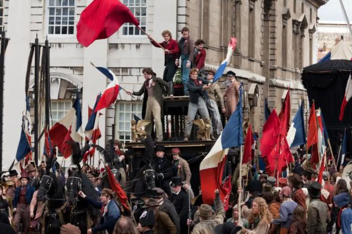 The students standing on a carriage, wave flags at the barricade in Paris