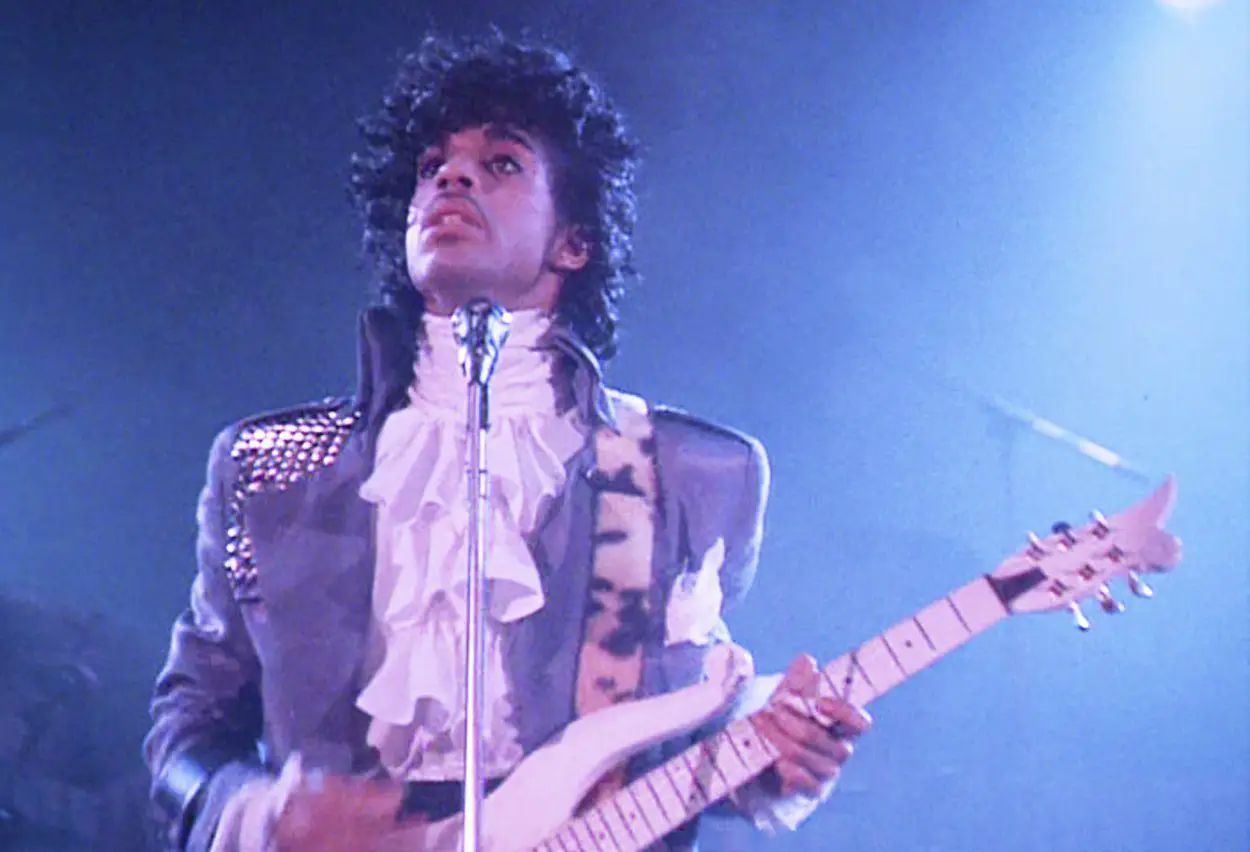 Classic image of Prince holding his guitar during Purple Rain performance