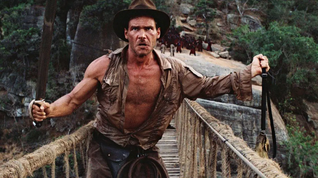 Indiana Jones crosses a bridge with a whip and a sword