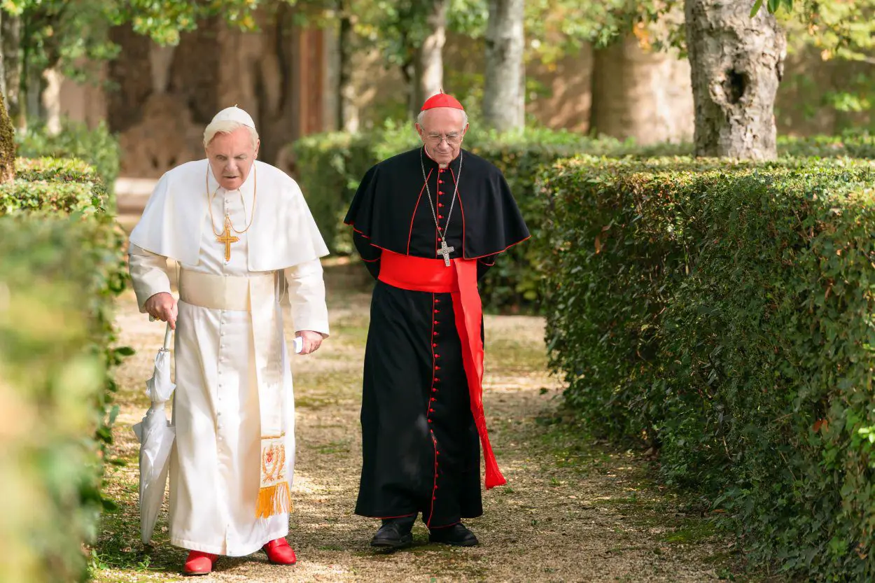 Pope Benedict XVI walks alongside Cardinal Jorge Mario Bergoglio in an outdoor garden