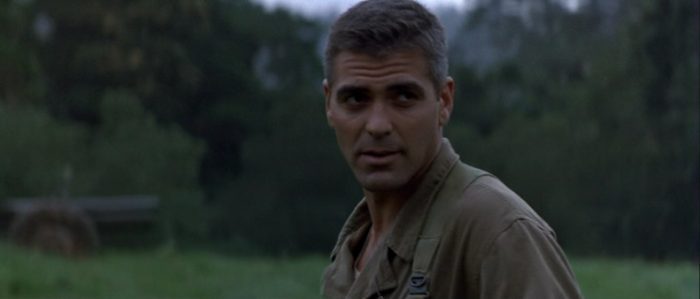 George Clooney stands in an empty field