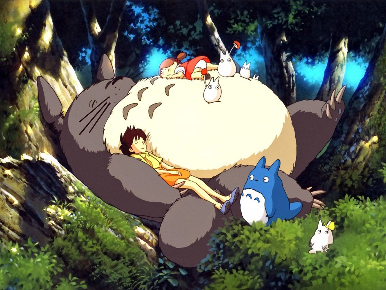 Totoro sleeps in the forest with the two sisters cuddling him, one lying on his belly and one under one arm