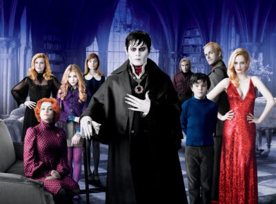 A group of people standing in a room dressed in Gothic style clothes