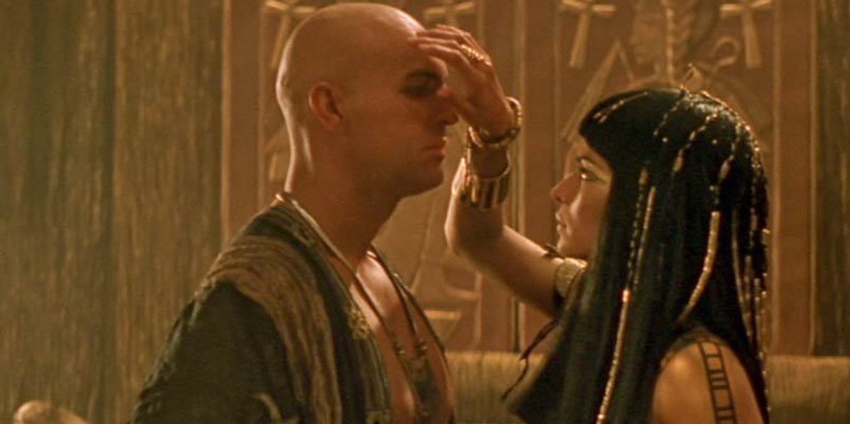 Imhotep and Anck Su Namun in The Mummy Anck Su Namun is holding a hand over Imhotep's face while Imhotep closes his eyes as they face each other